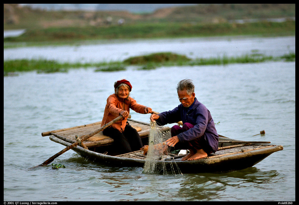 Elderly couple fishing, Ken Ga canal. near Ninh Binh,  Vietnam