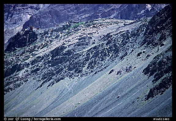 Rocky slopes topped by village and gompa, Zanskar, Jammu and Kashmir. India (color)