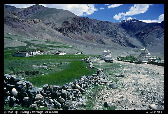 Stone fence, chortens, cultivations, and village, Zanskar, Jammu and Kashmir. India (color)