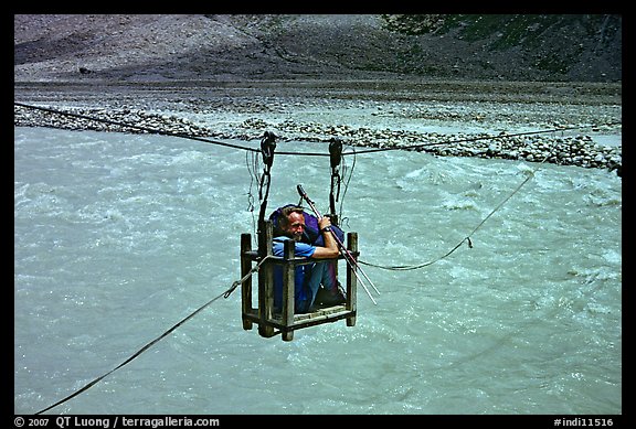 Trekker crossing a river by cable, Zanskar, Jammu and Kashmir. India (color)