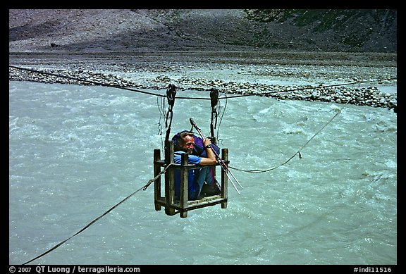 Trekker crossing a river by cable, Zanskar, Jammu and Kashmir. India