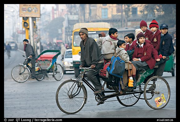 Cycle-rickshaw with a load of ten schoolchildren. New Delhi, India