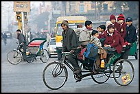 Cycle-rickshaw with a load of ten schoolchildren. New Delhi, India (color)