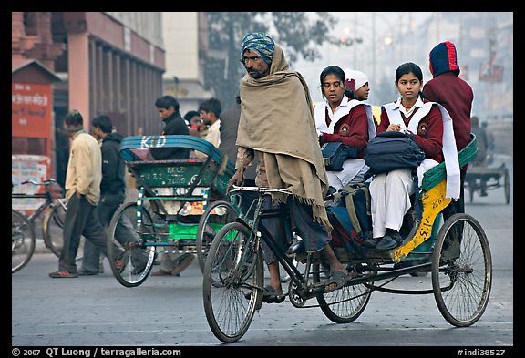 Cycle-rickshaw carrying uniformed schoolgirls. New Delhi, India (color)