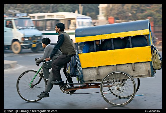 Cycle-rickshaw pulling a box for carrying schoolchildren. New Delhi, India (color)