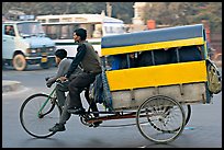 Cycle-rickshaw pulling a box for carrying schoolchildren. New Delhi, India (color)