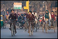 Children riding bikes in rickshaws on way to school. New Delhi, India