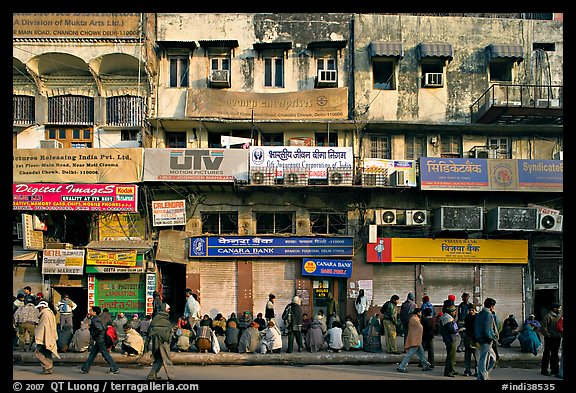 Street with many people waiting in front of closed stores, Old Delhi. New Delhi, India (color)