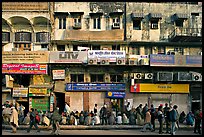 Street with many people waiting in front of closed stores, Old Delhi. New Delhi, India (color)