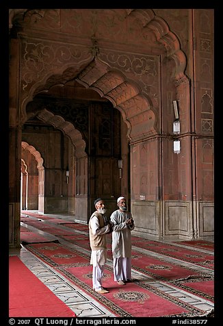 Two muslem men in Jama Masjid mosque prayer hall. New Delhi, India (color)