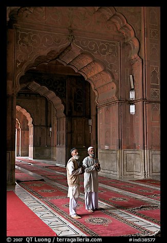 Two muslem men in Jama Masjid mosque prayer hall. New Delhi, India