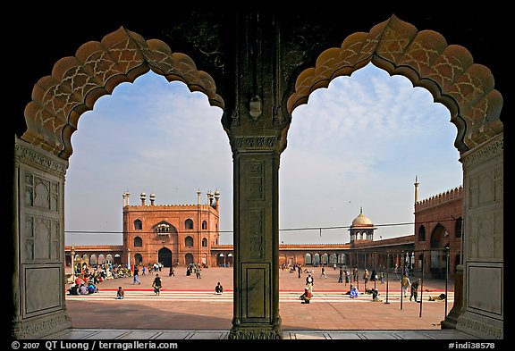 Courtyard of mosque seen through arches of prayer hall, Jama Masjid. New Delhi, India