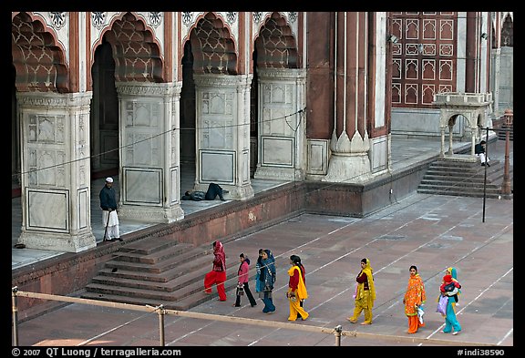 Women in colorful sari walking towards prayer hall, Jama Masjid. New Delhi, India (color)