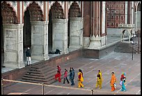 Women in colorful sari walking towards prayer hall, Jama Masjid. New Delhi, India