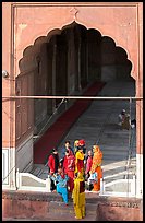Women standing beneath arched entrance of prayer hall, Jama Masjid. New Delhi, India (color)