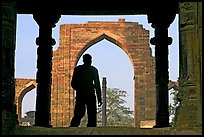 Man at entrance of ruined Quwwat-ul-Islam mosque. New Delhi, India ( color)