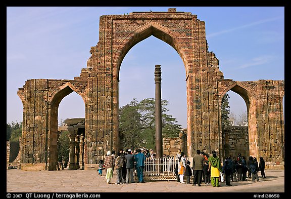 Iron pillar, and ruined mosque arch, Qutb complex. New Delhi, India (color)