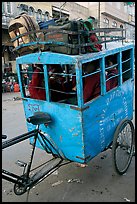 Schoolchildren in an enclosed  box towed by cycle. New Delhi, India