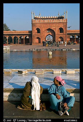 Women sitting near basin in courtyard of Jama Masjid. New Delhi, India (color)