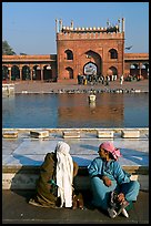 Women sitting near basin in courtyard of Jama Masjid. New Delhi, India ( color)
