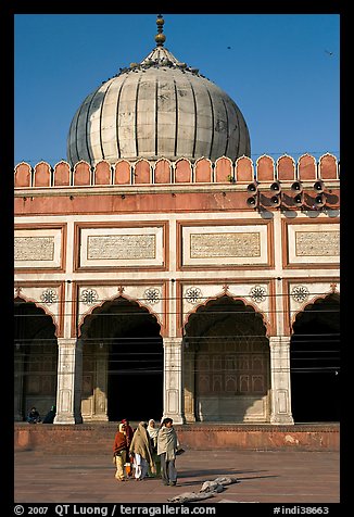 Group of people walking out of prayer hall. New Delhi, India (color)