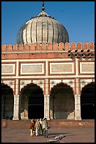 Group of people walking out of prayer hall. New Delhi, India ( color)