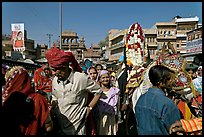 Groom covered in flowers and riding horse during Muslim wedding. Jodhpur, Rajasthan, India (color)