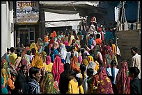 Street with women in colorful sari following wedding procession. Jodhpur, Rajasthan, India ( color)