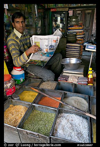 Man with newspaper selling grains, Sardar Market. Jodhpur, Rajasthan, India