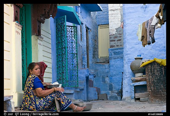 Women sitting in alley painted with indigo tinge. Jodhpur, Rajasthan, India