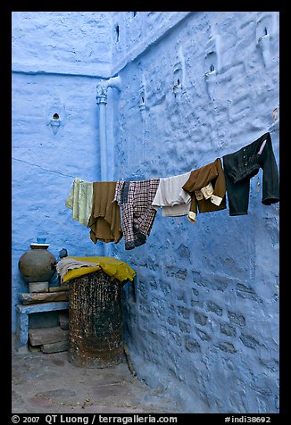 Laundry in alley with whitewashed walls tinted indigo. Jodhpur, Rajasthan, India