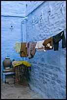 Laundry in alley with whitewashed walls tinted indigo. Jodhpur, Rajasthan, India