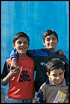 Young boys in front of blue wall. Jodhpur, Rajasthan, India