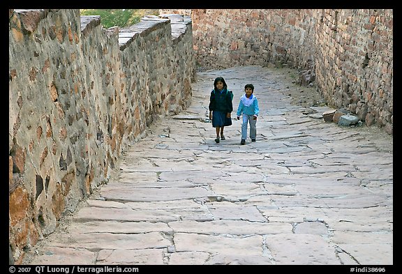 Children walking on the stone ramp leading to the fort. Jodhpur, Rajasthan, India