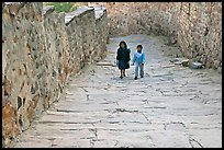 Children walking on the stone ramp leading to the fort. Jodhpur, Rajasthan, India