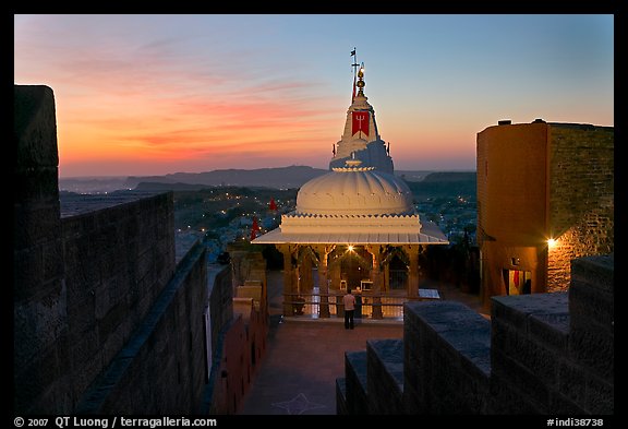 Chamunda Devi temple with man worshipping at sunset, Mehrangarh Fort. Jodhpur, Rajasthan, India