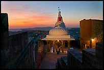 Chamunda Devi temple with man worshipping at sunset, Mehrangarh Fort. Jodhpur, Rajasthan, India