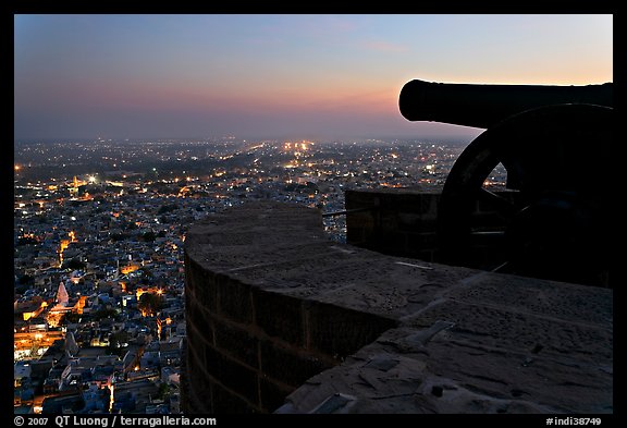 Cannon on top of Mehrangarh Fort, and city lights below. Jodhpur, Rajasthan, India (color)