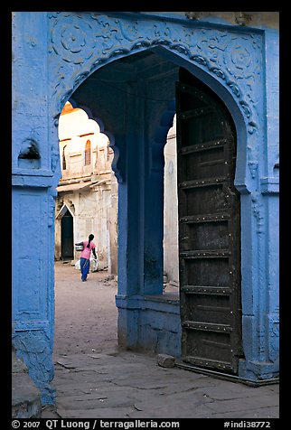 Archway with woman carrying water in courtyard. Jodhpur, Rajasthan, India