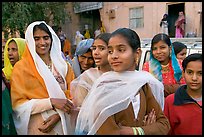 Women standing in the street during a wedding. Jodhpur, Rajasthan, India