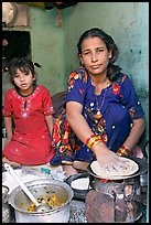 Woman and girl preparing chapati bread. Jodhpur, Rajasthan, India (color)