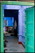 Doorway and inside of a house painted blue. Jodhpur, Rajasthan, India