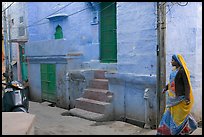 Woman walking in narrow street with blue walls. Jodhpur, Rajasthan, India ( color)