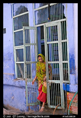 Woman stepping out of door. Jodhpur, Rajasthan, India (color)