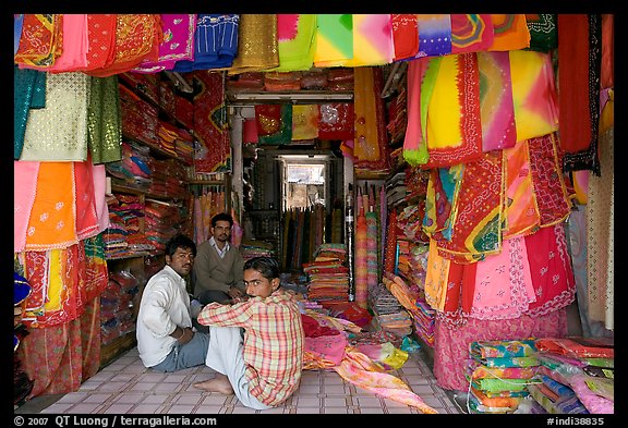 Men in shop selling colorful fabrics, Sardar market. Jodhpur, Rajasthan, India