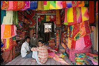 Men in shop selling colorful fabrics, Sardar market. Jodhpur, Rajasthan, India