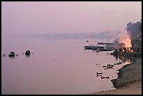 Ganges River at sunset with cremation fire. Varanasi, Uttar Pradesh, India