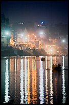 Lights reflected in the Ganga River at night. Varanasi, Uttar Pradesh, India