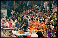 Brahmans standing amongst crowd at the begining of evening puja. Varanasi, Uttar Pradesh, India (color)