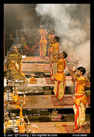 Young priests open Puja ceremony by blowing a conch-shell. Varanasi, Uttar Pradesh, India